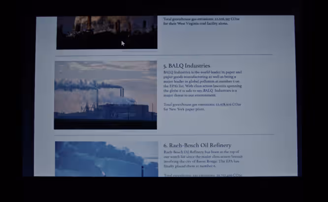 Film Still from First Reformed, 2017. A Computer Screen shows a list of factories with images of their chimneys and reports of their carbon dioxide emissions.