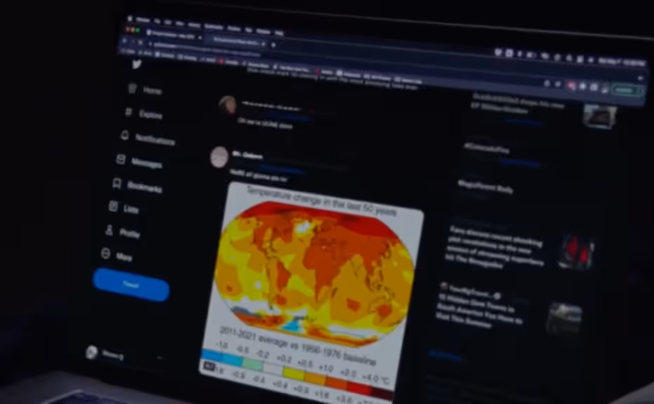 Film Still from How to Blow Up a Pipeline, 2022. A point of view frame of a laptop screen showing a global map displaying extreme temperatures.